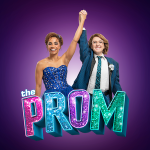 Two young women in formal clothing with hands clasped above their heads over The Prom logo