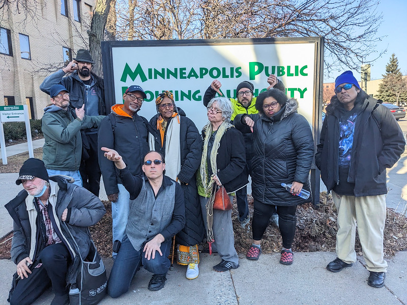 A group of bored and angry people gathered outside of the Minnesota Public Housing Authority building