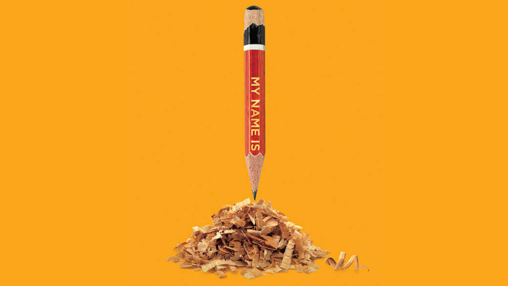 A red pencil with My Name Is inscribed on the side emerges vertically from a pile of pencil shavings.